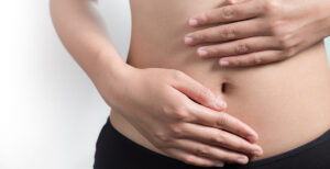 woman with hands on stomach