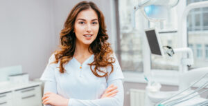 A confident aesthetician standing in front of her equipment.