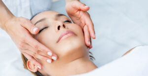 A woman getting her face treated at a spa.