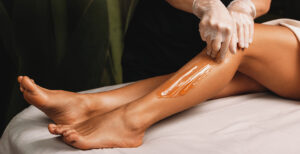 A woman getting her legs waxed.