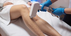 someone getting a laser treatment done on their legs to remove hair