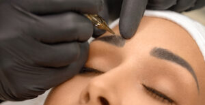 woman getting microbladding done on her eyebrows