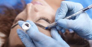 A professional doing microblading on a woman