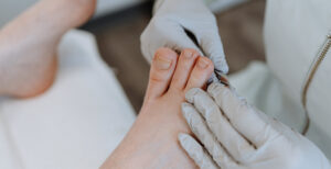 nail technician doing a pedicure on a client
